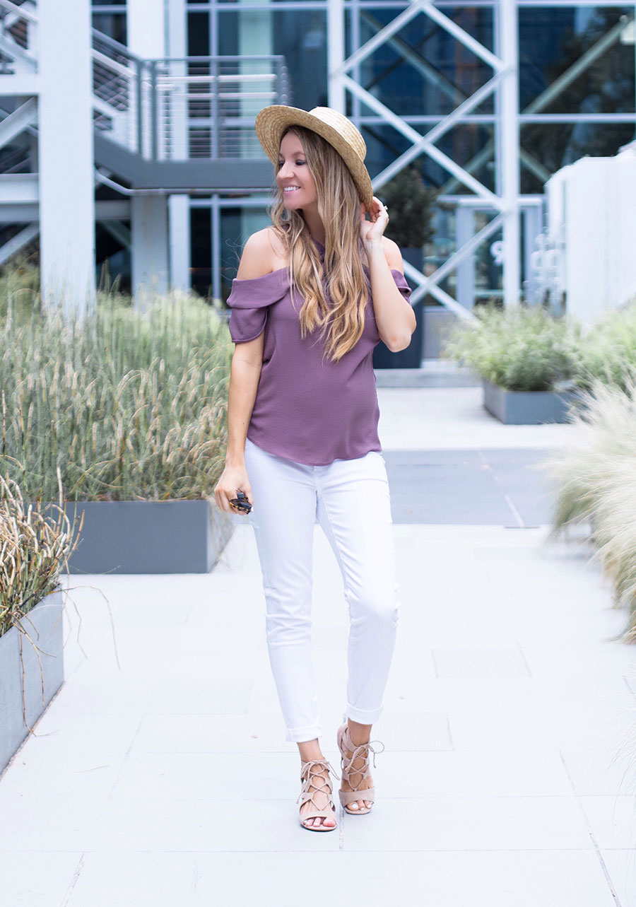 purple off the shoulder top and white jeans 