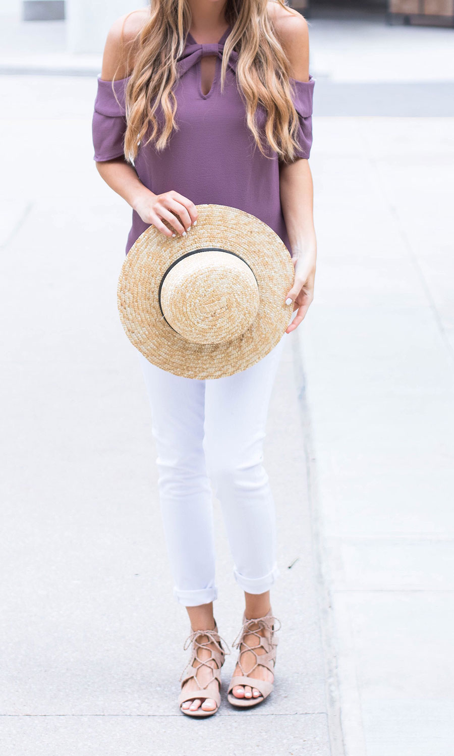 purple off the shoulder top and white jeans 